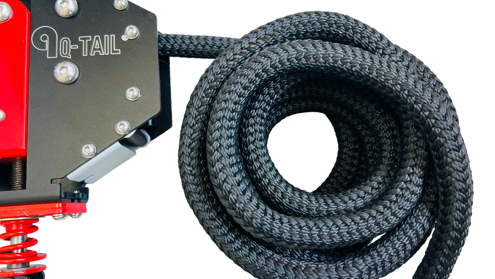 Coiled black Q-Tail rope beside the trainer housing