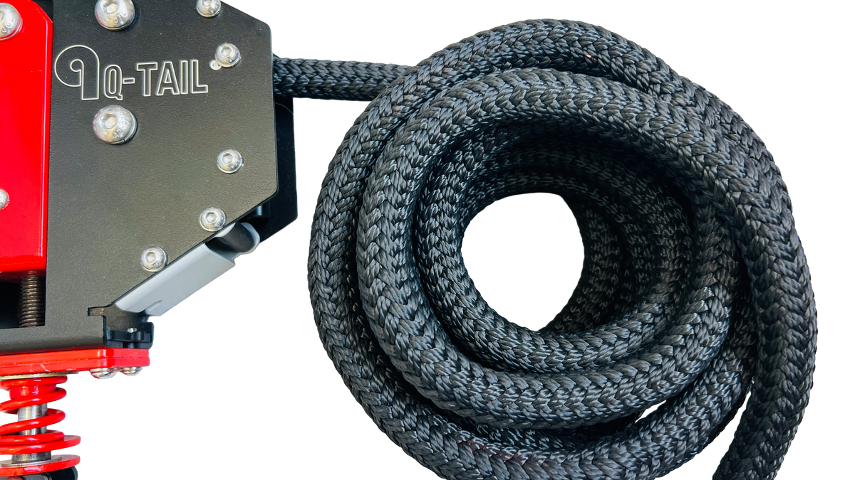 Coiled black Q-Tail rope beside the trainer housing