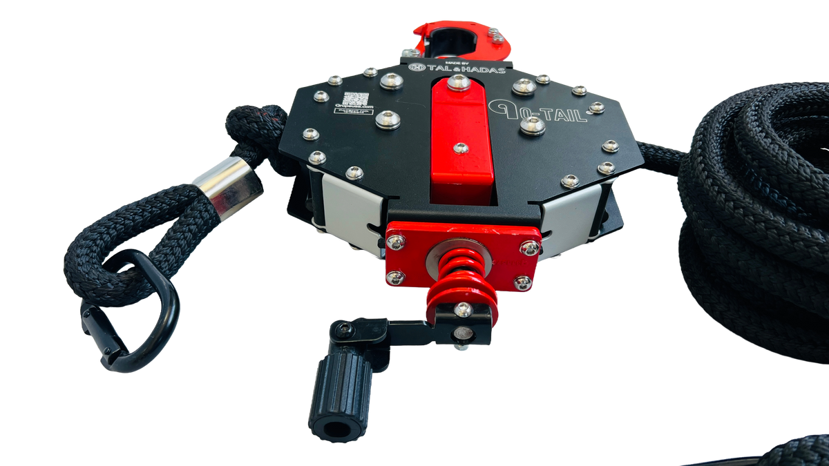 Angled view of the Q-Tail trainer with its adjustment knob and rope loop handle